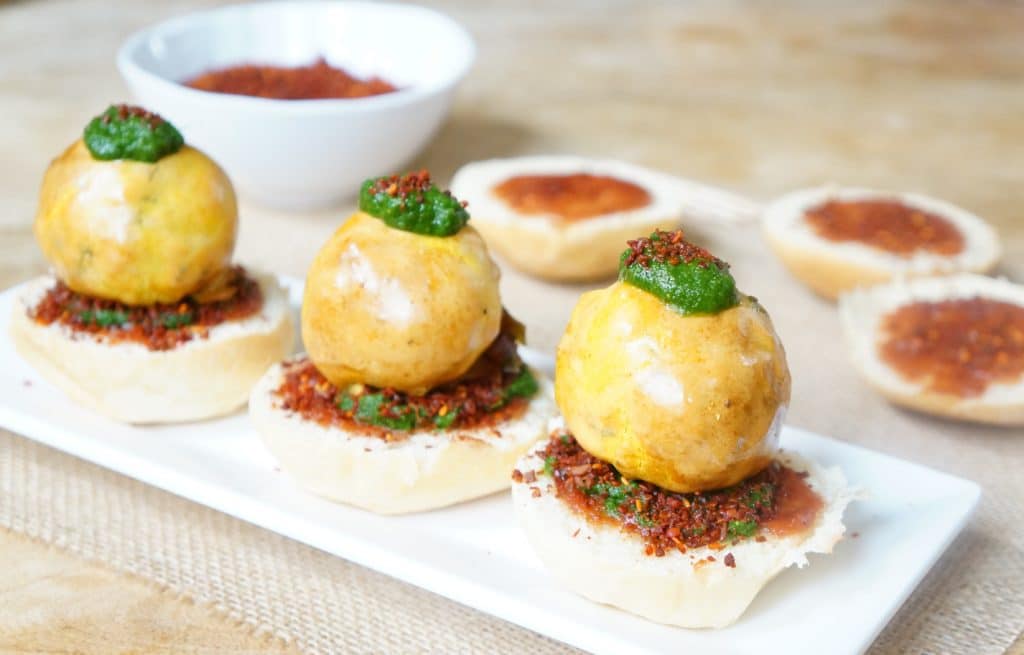 Potato fritter sliders arranged nicely on a long white tray