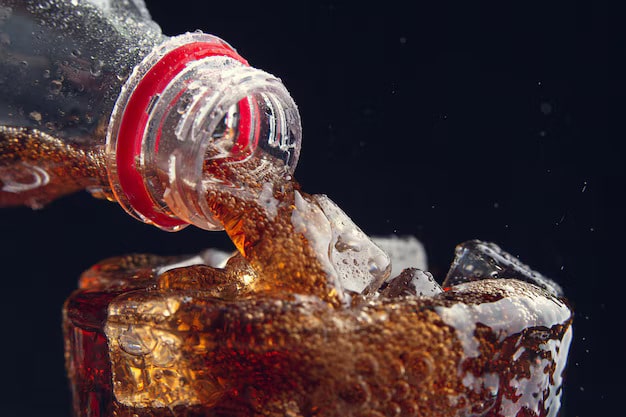 Close up of soda being poured over ice