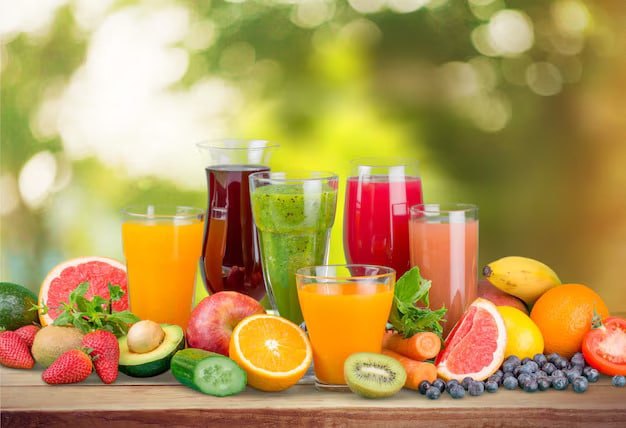 Fresh fruit juices with fruits on wooden table