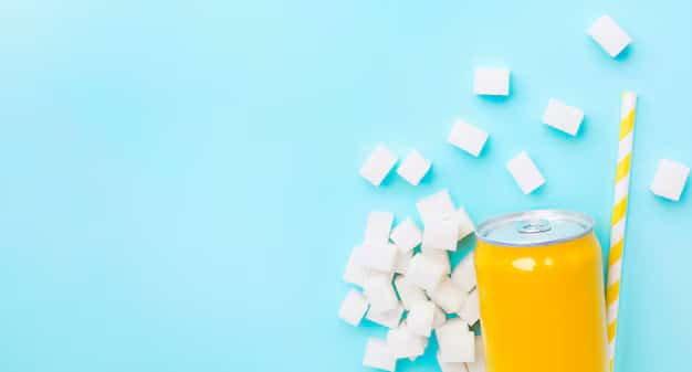 Sugary soda can with sugar cubes around