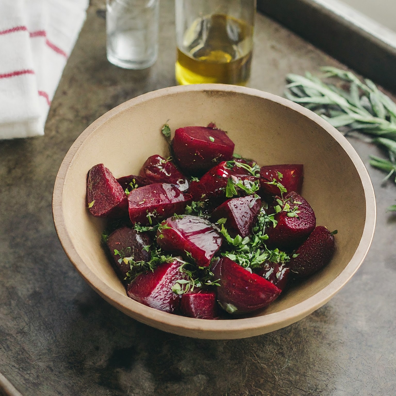 A bowl of beetroots garnished with fresh herbs