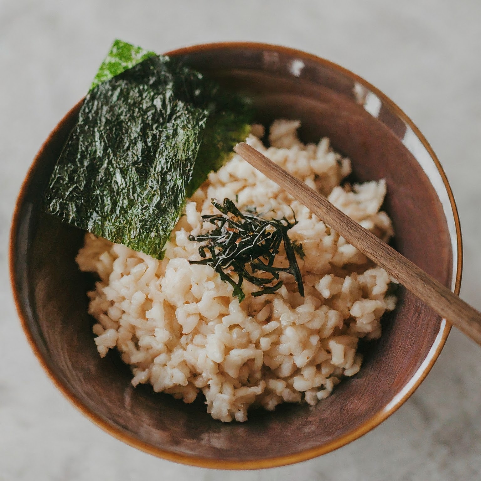 A bowl of cooked brown rice with a chewy texture