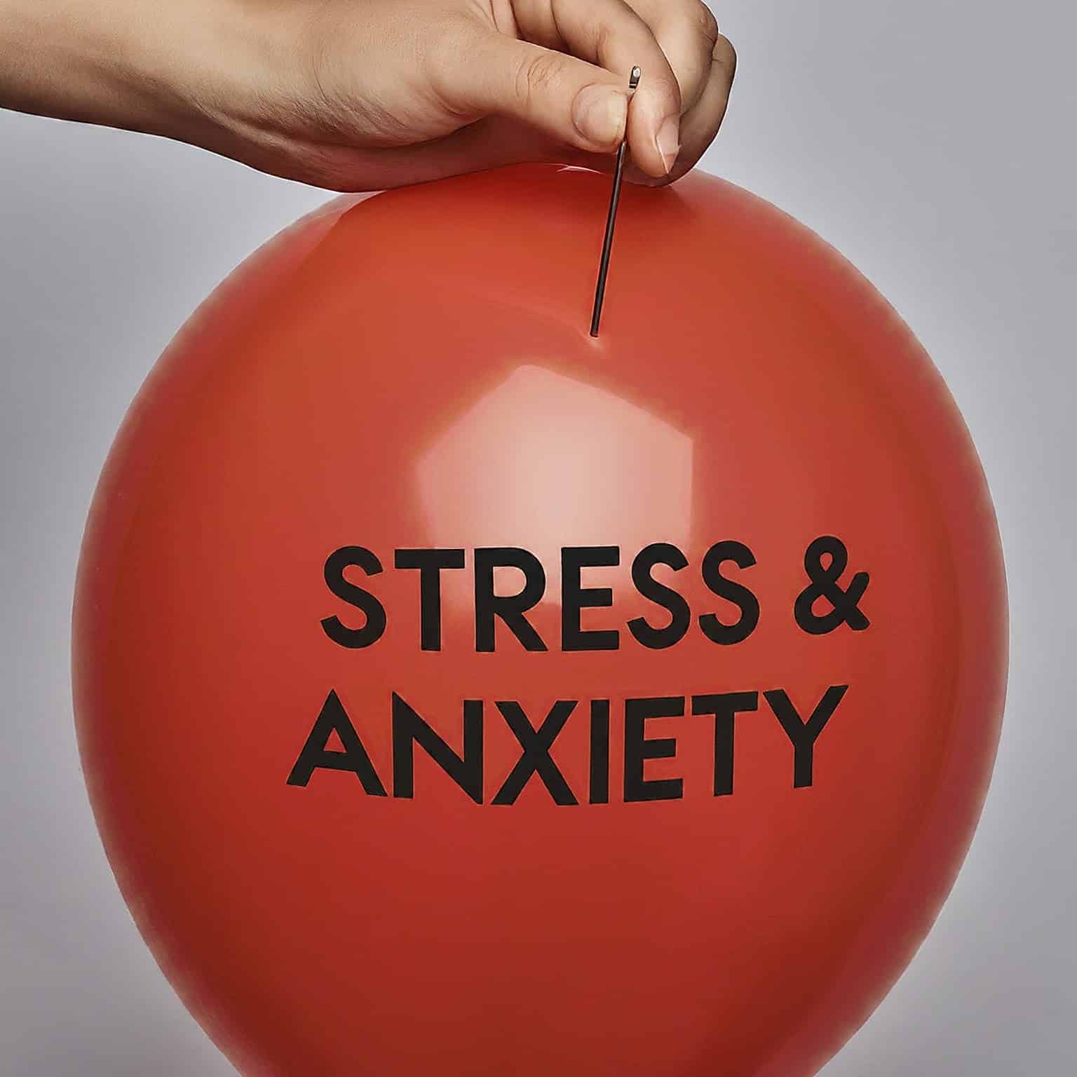 A balloon with the words "stress and anxiety" written on it, with a pin hovering above it, ready to burst.