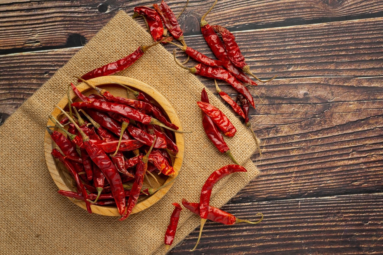 Fresh Guntur chillies with vibrant red colour.