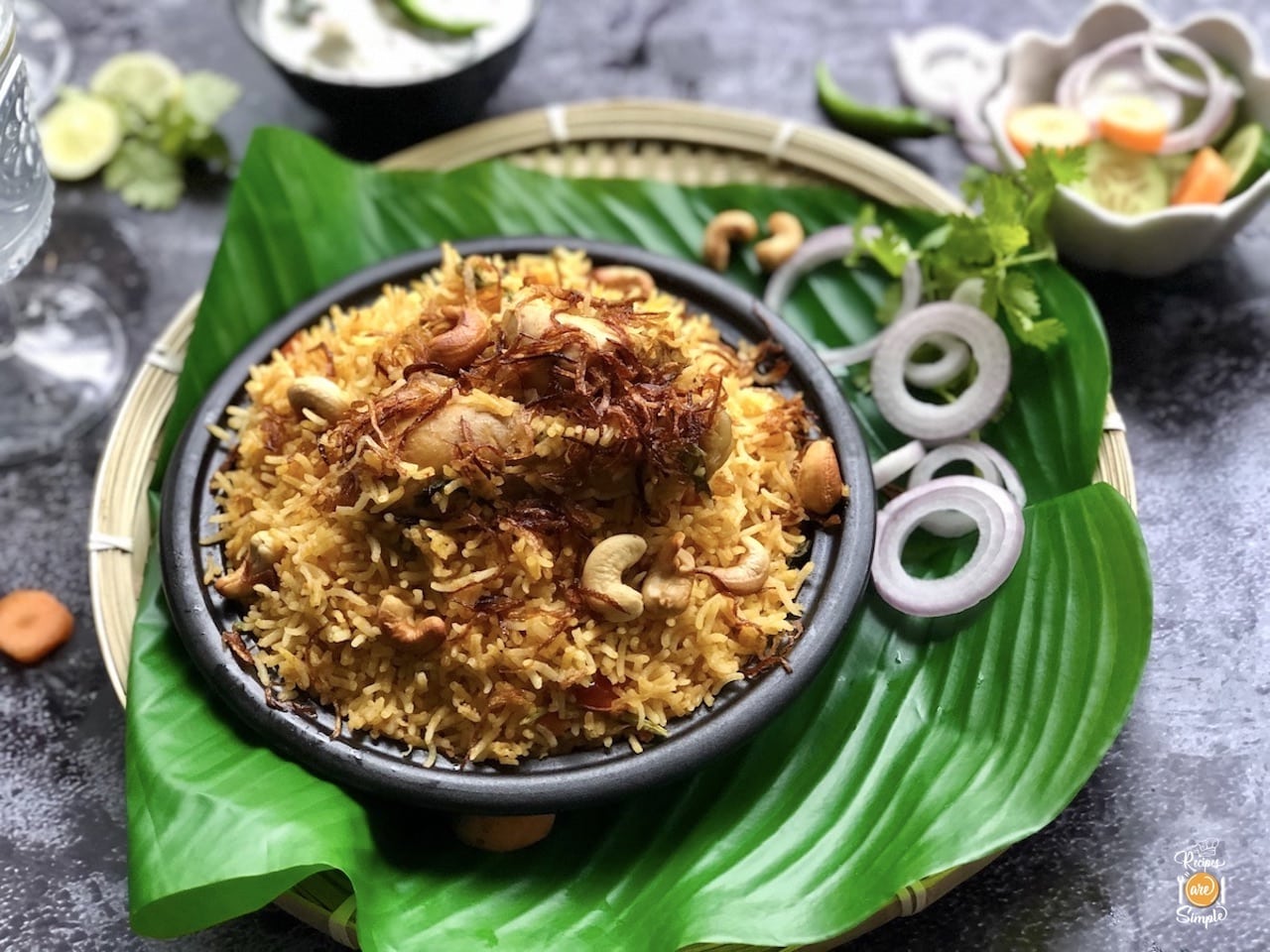 Lucknowi biryani set in a bowl placed on a green leaf