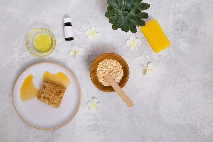 Ghee a natural ingredient is shown with oats honey and essential oil for skincare and hair care