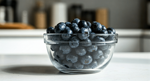 Fresh blueberries in a glass bowl.