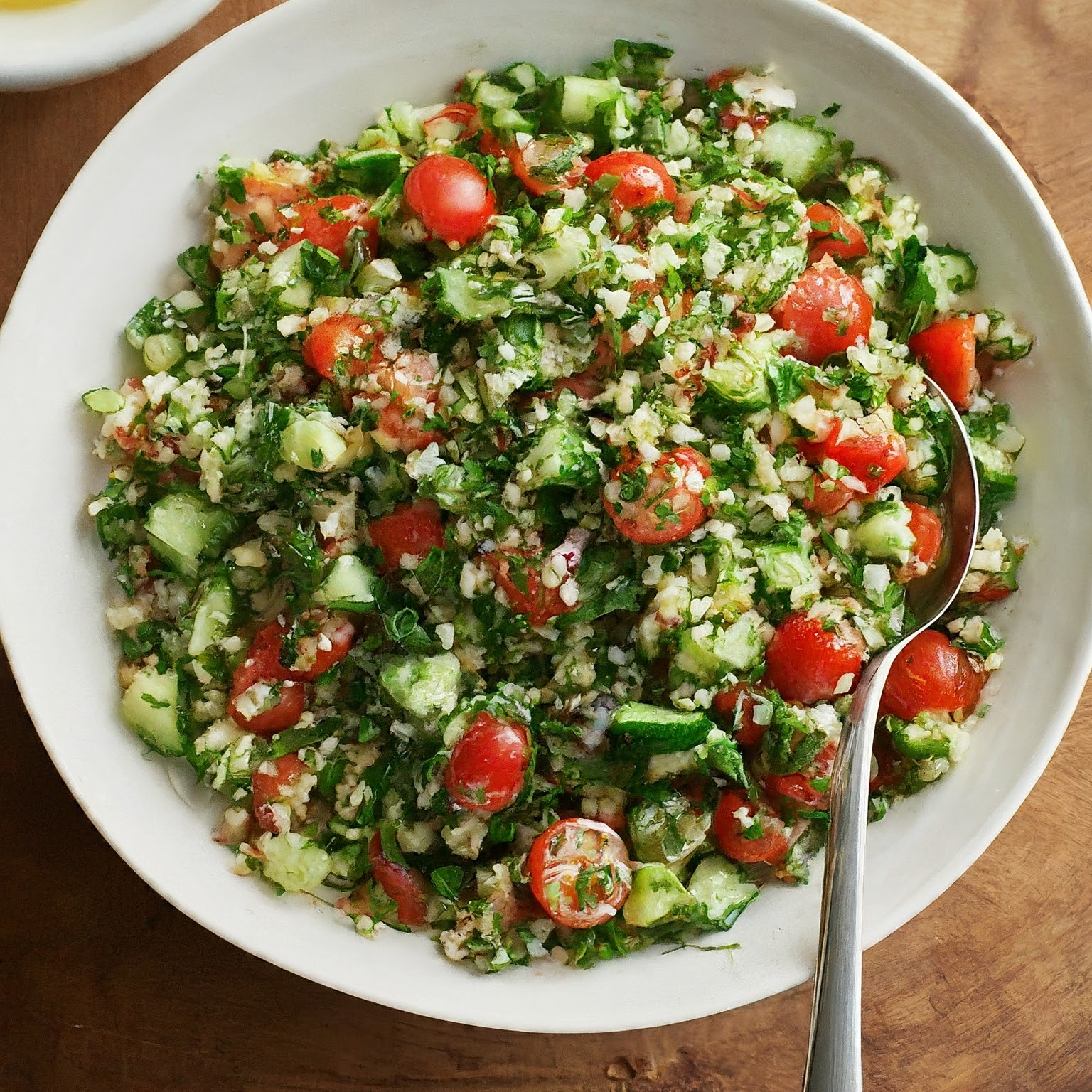 A bowl of Middle Eastern Tabbouleh salad made with finely chopped parsley tomatoes cucumbers and bulgur wheat tossed in a tangy lemon olive oil dressing 