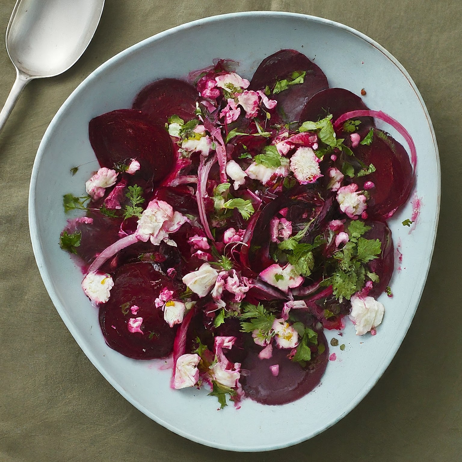 A vibrant Australian beetroot salad featuring thinly sliced beets tossed with feta cheese walnuts and a tangy vinaigrette 