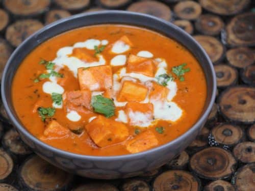 Creamy paneer butter masala with cilantro garnished on the top