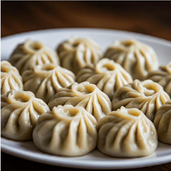 A close up of a plate of steaming hot momos a famous dish from Sikkim