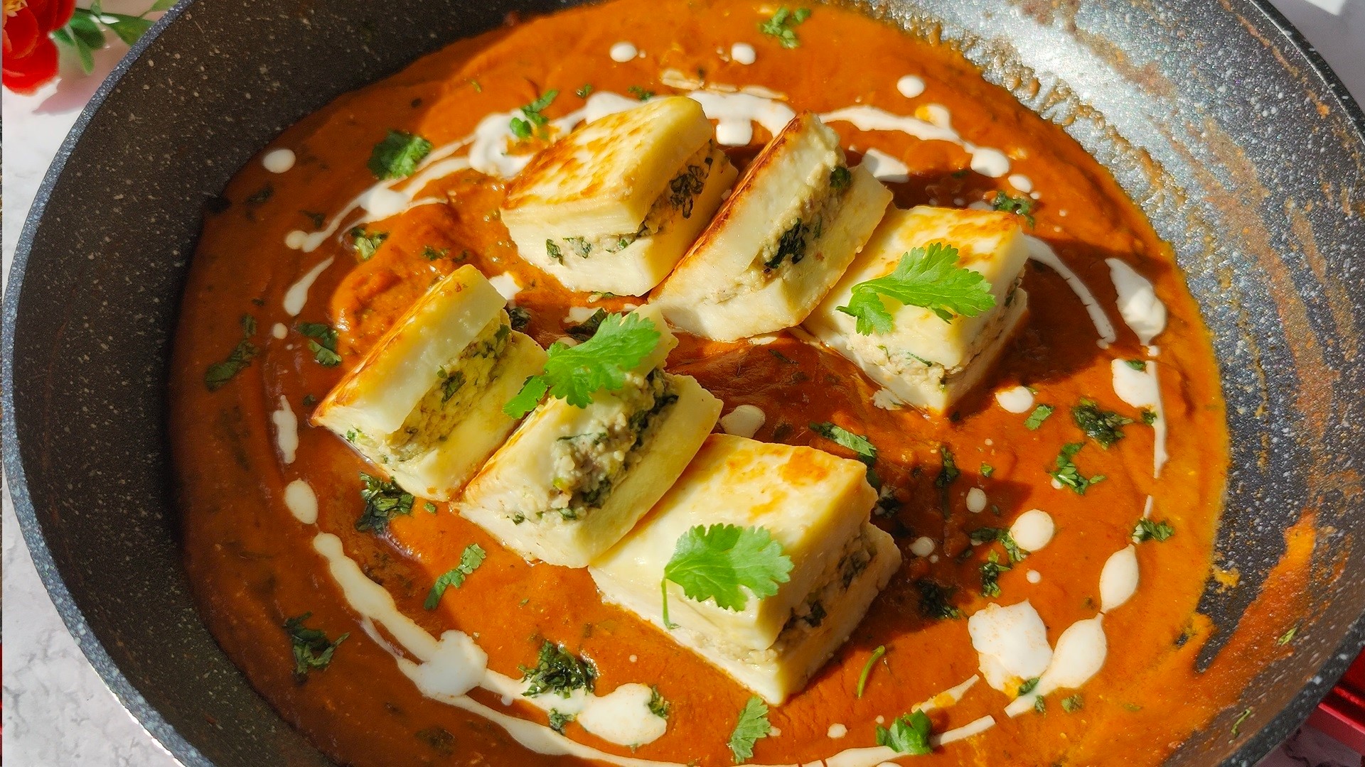 paneer pasanda made with rich gravy, tomato and onions in a pan